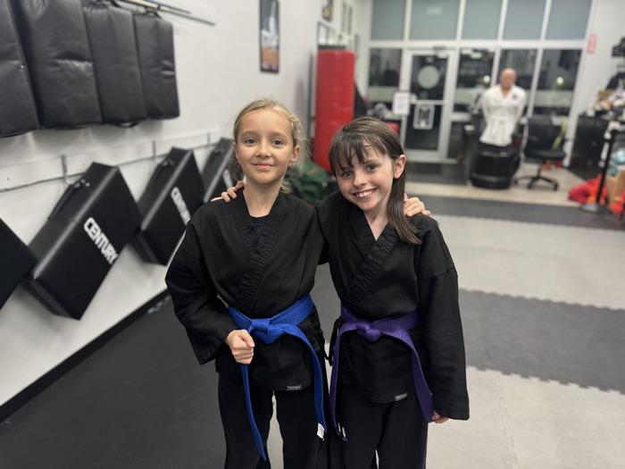 Two smiling young students after karate class
